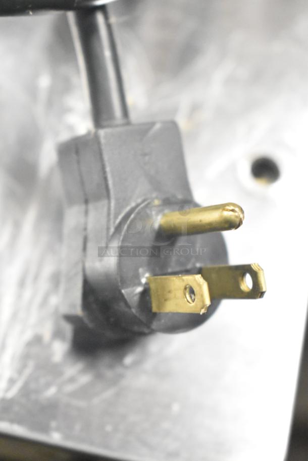 Close-up of a power plug for the 2024 Delfield 4460NP-24M Commercial Sandwich Salad Prep Table, 115 Volts, 1 Phase.