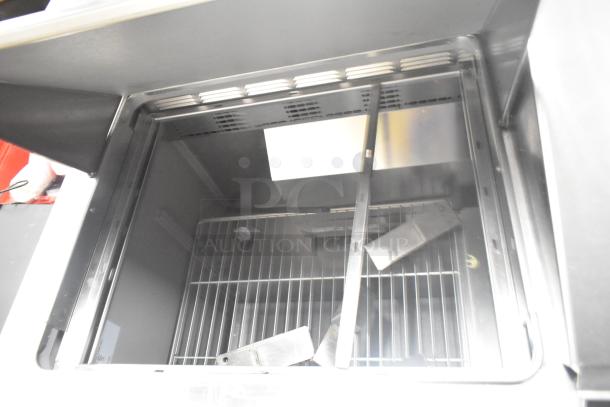 2024 Delfield 4460NP-24M commercial sandwich salad prep table interior view, showing shelves and clean stainless finish.