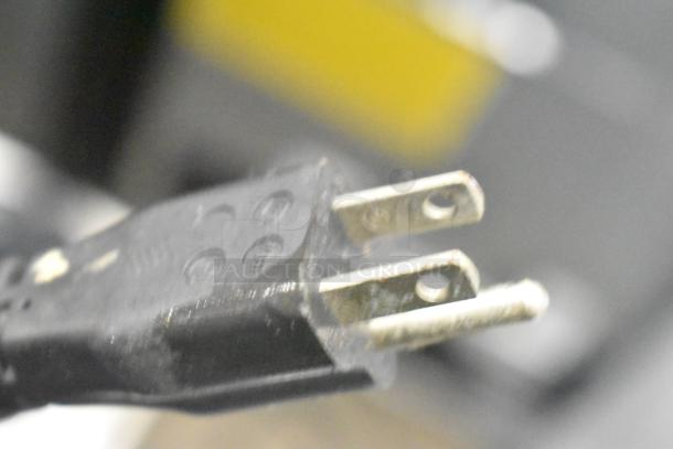 Close-up of a standard 115-volt power plug for the Espresso Italia Easy Cup 300 espresso machine.