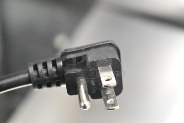 Close-up of a three-prong plug from the Vissani MDBF18SS cooler. Plug is black, standard U.S. type, suited for 115 Volt outlets.