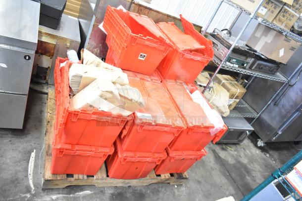 13 red poly bins filled with napkins, holding bin drop-ins, cups, and utensils, stacked on a pallet. Auction lot.