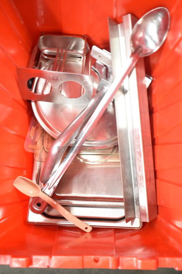 Red poly bin containing metal utensils, trays, napkins, and dedicated holding bin drop-ins. Includes 13 bins total.
