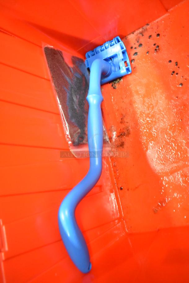 13 red poly bins containing miscellaneous items including napkins, cups, and utensils. Features holding bin drop-ins.