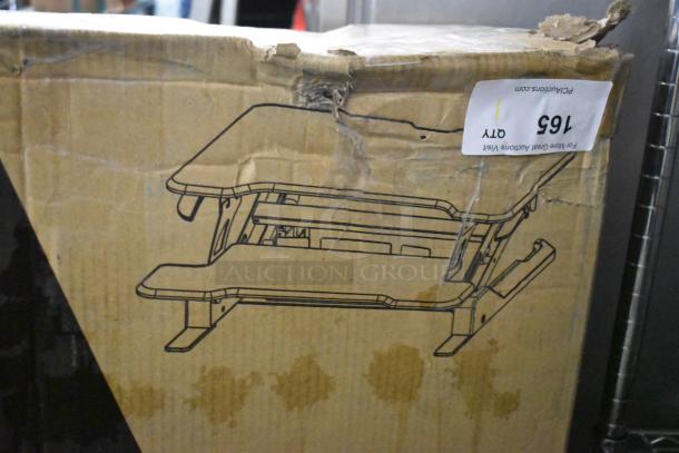 Original box of Mount-it! Compact Standing Desk Converter, visible wear on packaging, label with auction details.