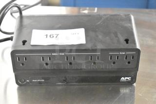 APC Back-UPS 425 Uninterruptible Power Supply, black, with 8 outlets for battery and surge protection. Label: Lot 167.