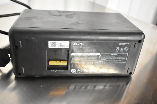 APC Uninterruptible Power Supply, Model BE425M, 120V, with battery backup, visible labels, signs of wear.