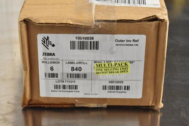 Cardboard box containing Zebra 10010036 labels, 6 rolls/box, 840 labels/roll. Marked as "Multi-pack, Do Not Break Open."