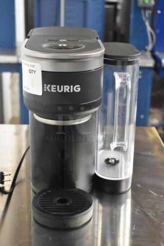 Keurig K91 Single Serve Coffee Maker, black, with clear water reservoir. Model K91, 120V, 1 phase. Appears in good condition.