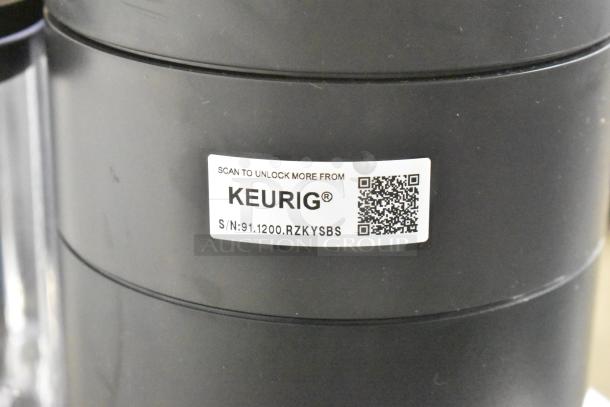 Keurig K91 Single Serve Coffee Maker, black, with QR code and serial number label. Model: K91. 120 Volts, 1 Phase.