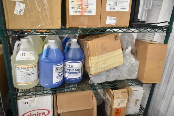 Various cleaning supplies on shelves, including Noble Low Temp Sanitizer, Noble Dry It Low Rinse, boxed items, and liquids.