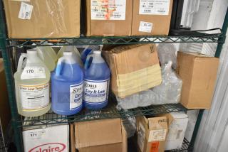 Various cleaning supplies on shelves, including Noble Low Temp Sanitizer, Noble Dry It Low Rinse, boxed items, and liquids.