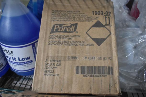 Alt text: Auction lot with Noble Low Temp Sanitizer, Noble Dry It Low Rinse Agent, GoJo Foam Handwash, Purell Hand Sanitizer box with expiry July 2028.