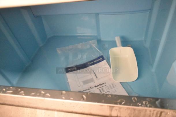 BRAND NEW Avantco 194EUCF340A ice machine interior with manual and scoop. Scratch and dent condition, 99 lb. bin, 340 lb. capacity.
