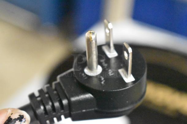 Close-up of a three-prong plug from a brand new Avantco 177RCB124 electric rice cooker, highlighting its connectivity.