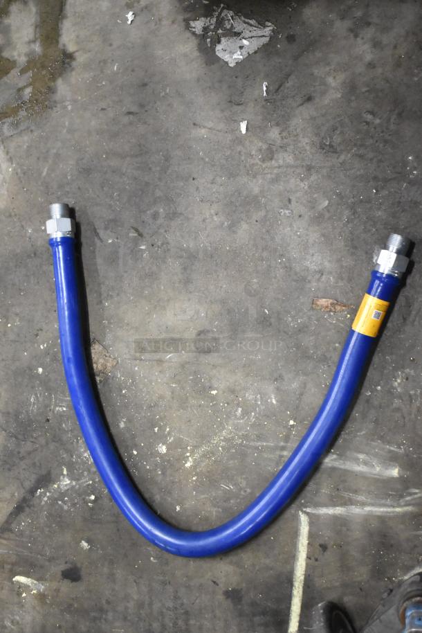 Blue gas hose with metal fittings, part of a scratch and dent auction lot. New condition, visible label attached.