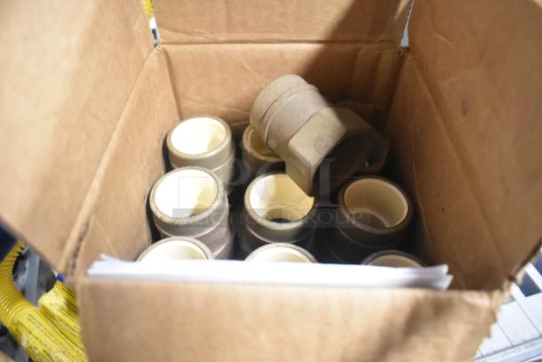 Cardboard box with multiple brass adapters, featuring CPVC interiors. New, scratch and dent condition. Sioux Chief 646-CG5 model.