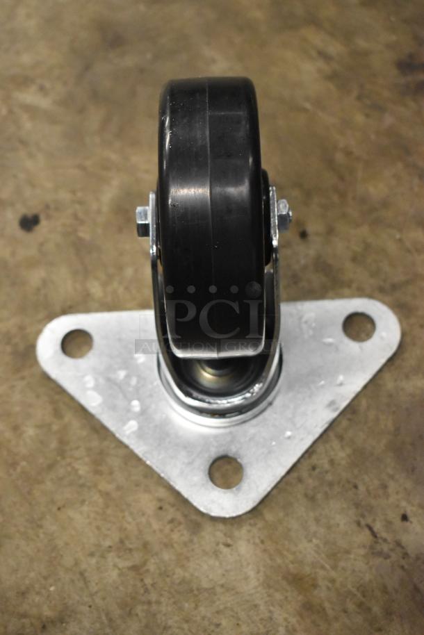 Brand new caster with black wheel and metal mounting plate, slight scratches visible. Part of a lot of 4 casters.
