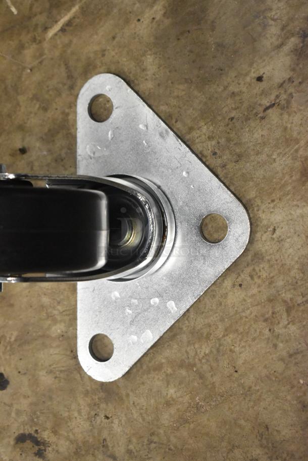 Lot of 4 brand new casters, slight scratches. Metal mounting plate with three holes, black wheel.