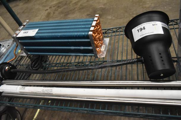 Alt text: Brand new CK7416D0170 warming lamp, 120 volts, 1 phase. Features minor scratches and dents, auction tags visible.