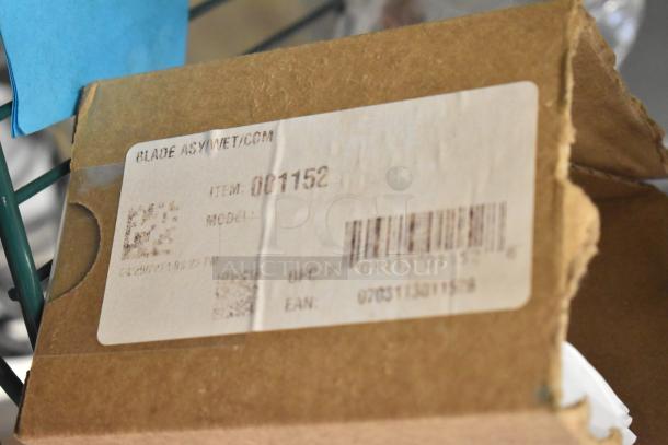 Cardboard box labeled "Blade Assembly Wet/CCM" with item number 001152, UPC code, and scratch marks.
