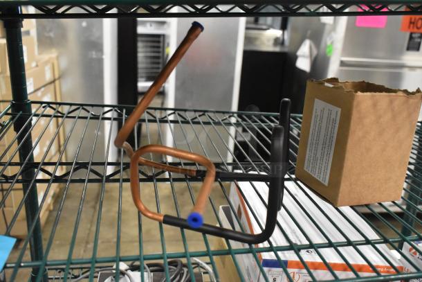 Copper Turbo Air CONLOOP2848 condensate loop, new, slight dent visible. Brown box with label detailing usage instructions.