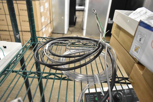 BRAND NEW 2025 Manitowoc IAuCS-161 Ice Machine Cleaner, scratch and dent, 115V, 1 Phase, coiled cables on wire shelf.