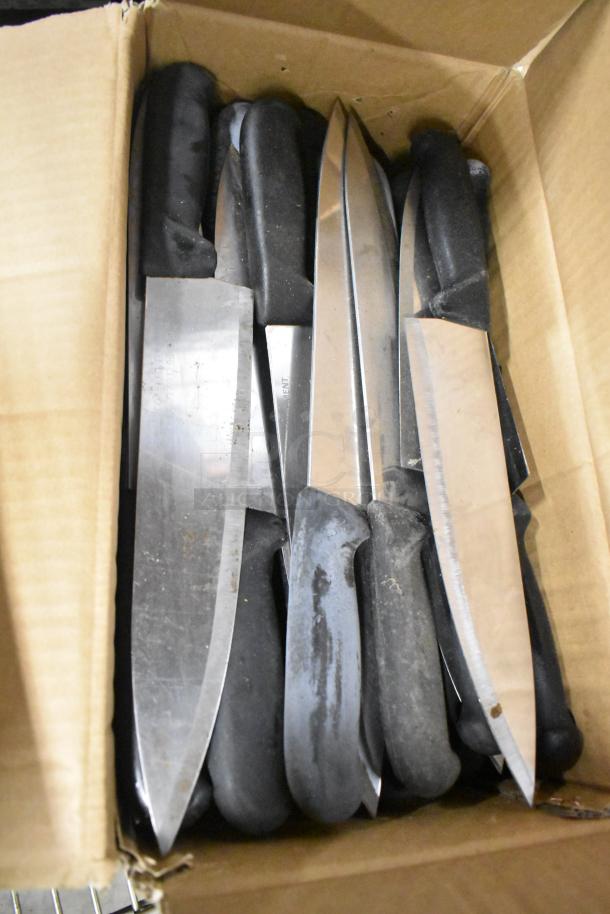 Box of 100 sharpened stainless steel knives, including chef and serrated bread knives, with black handles.