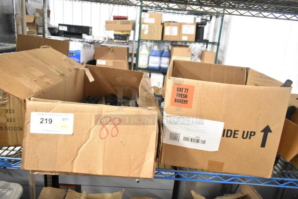 Two open boxes containing 120 sharpened stainless steel knives, including filet knives, in varying conditions. Box labels indicate auction lot details.