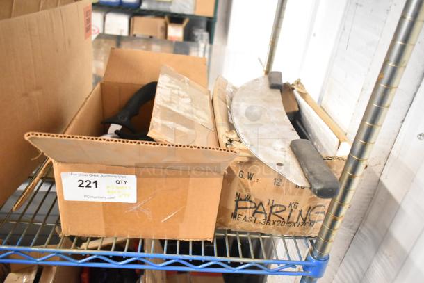 58 sharpened stainless steel items including pizza and dough cutters, paring knives, in cardboard boxes on a metal shelf.