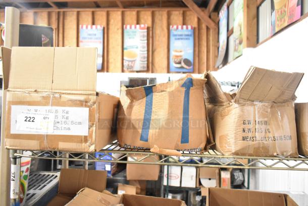 200 sharpened stainless steel knives, including filet, serrated, and rocking cutter, in original packaging, stored on a shelf.