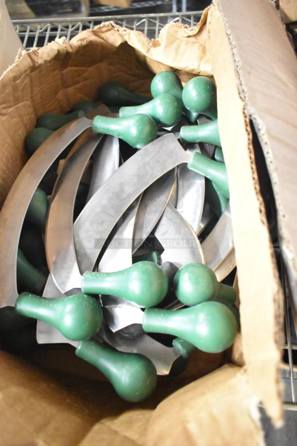 Box of sharpened stainless steel knives with green handles, including filet, serrated, and rocking cutter types.