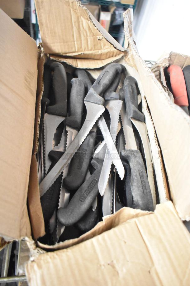 Cardboard box filled with 200 sharpened stainless steel knives, including filet, serrated, and rocking cutter types, black handles.