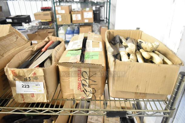 Boxes of 180 sharpened stainless steel knives, including chef and serrated types. Labels note bid multiplier, Zini Cutlery.
