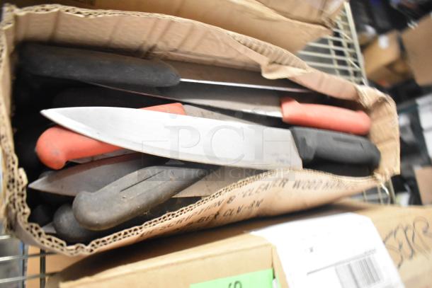 Box of 180 sharpened stainless steel knives, including chef and serrated knives, with red and black handles.