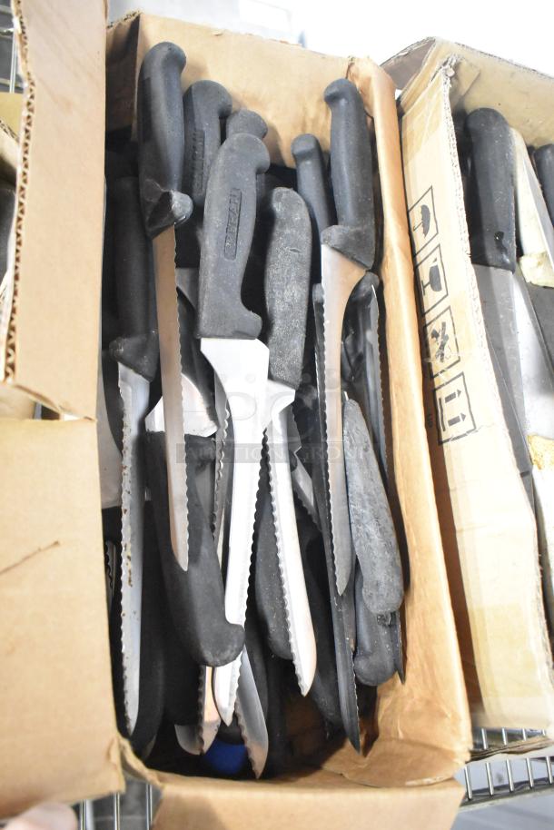 Box of 180 sharpened stainless steel knives, including chef and serrated types, with black handles in good condition.