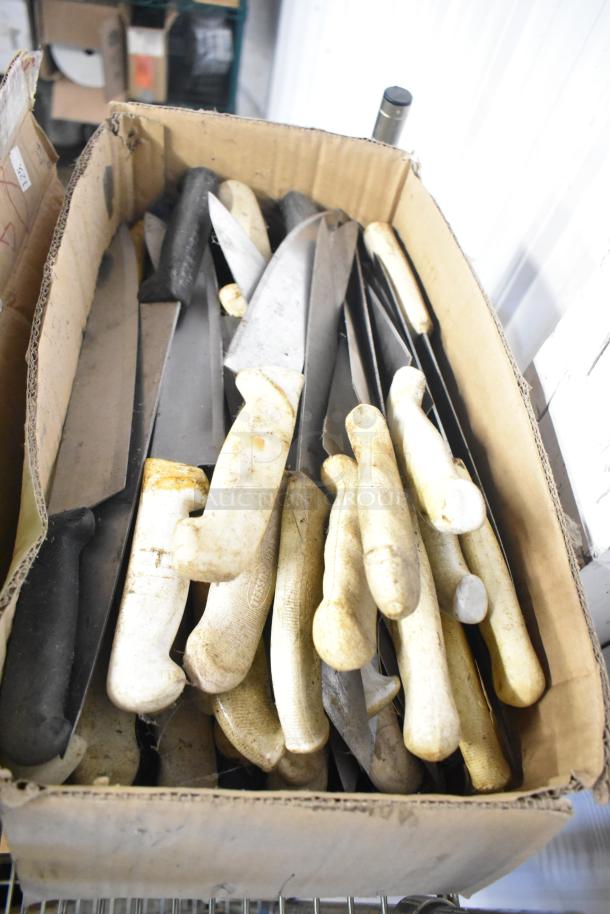 Box of 180 sharpened stainless steel knives, including chef and serrated knives, varying handle colors, used condition.