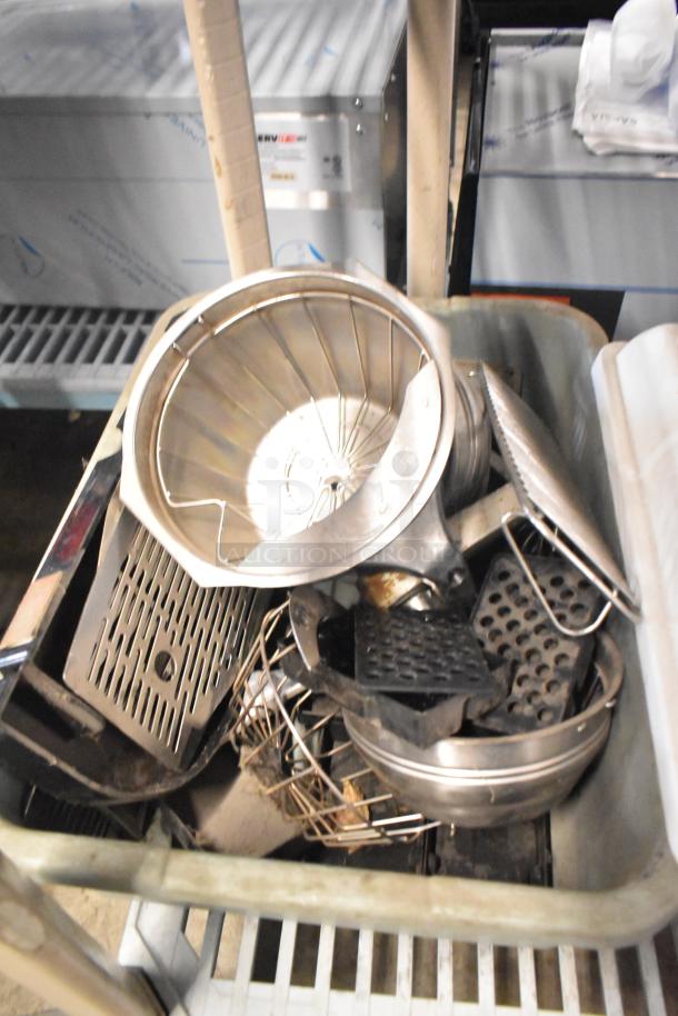 Tiered lot of various metal items including brew baskets and drip trays, showing signs of use.