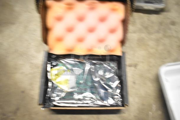 Mixed item lot featuring brew baskets and drip trays in a tiered setup, partially visible with packaging materials.