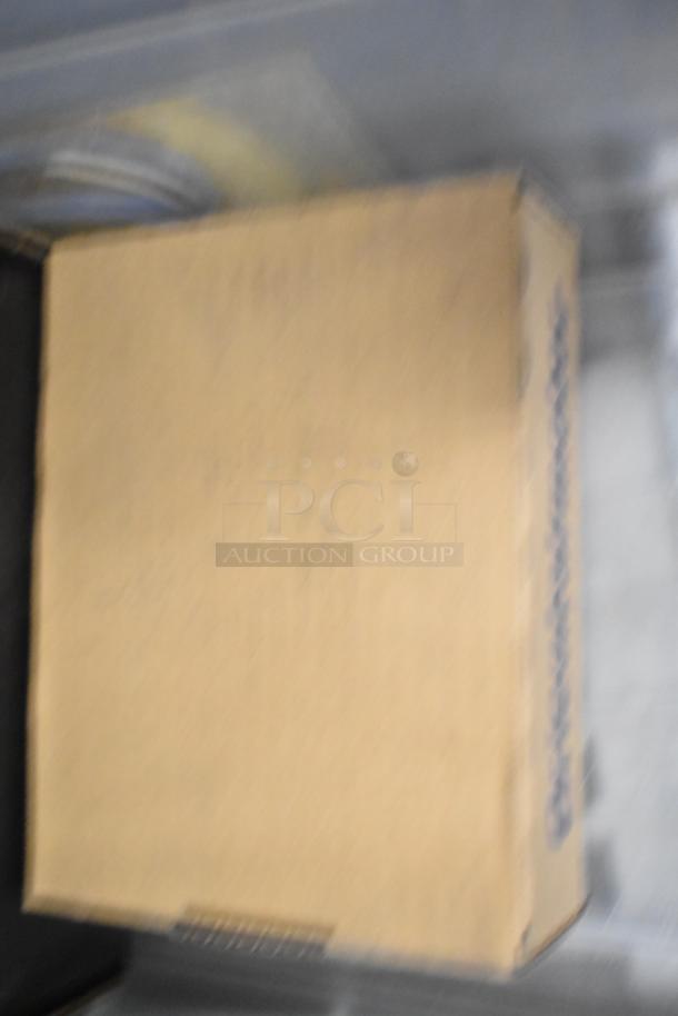 Blurred image of a cardboard box. Contains a tier lot with brew baskets and drip trays. Condition and specific items unclear.