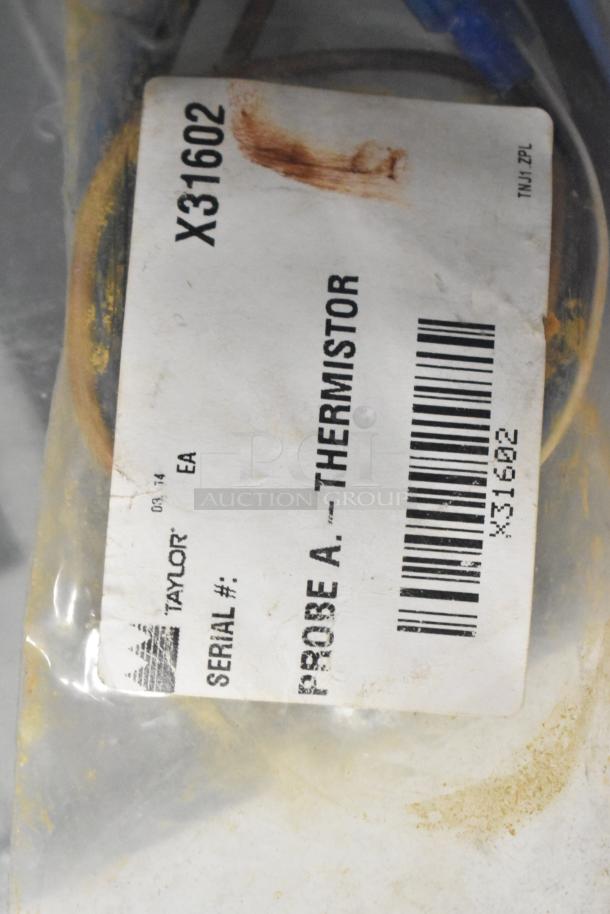 Plastic bag with a Taylor label reading "Probe A - Thermistor," serial no. X31602, indicates part identification.