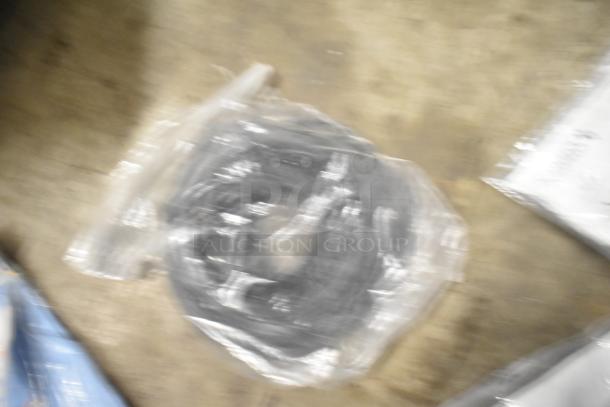 Blurry image of a bagged item from a mixed lot including brew baskets and drip trays. Condition unclear.