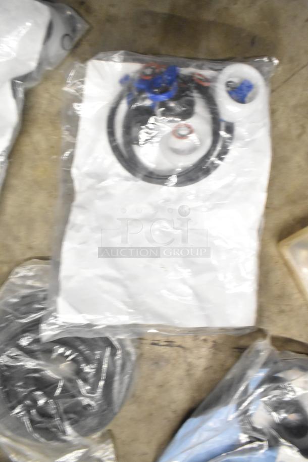 Tier lot with brew baskets and drip trays, various items in sealed plastic bags, appearing unused and in good condition.