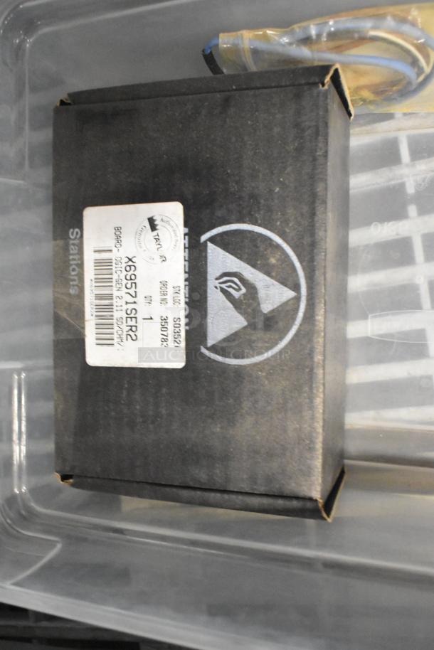 Tiered lot including brew baskets and drip trays. Box labeled "X6X571SER2," in fair condition.