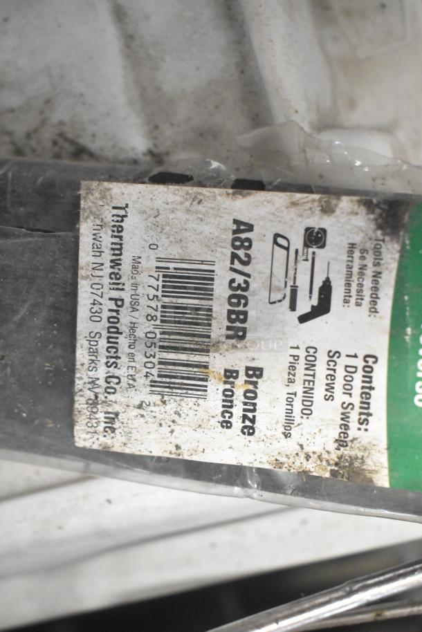 "ALL ONE MONEY" tier lot includes brew baskets, drip trays; label shows Thermwell Products door sweep, bronze, with screws.