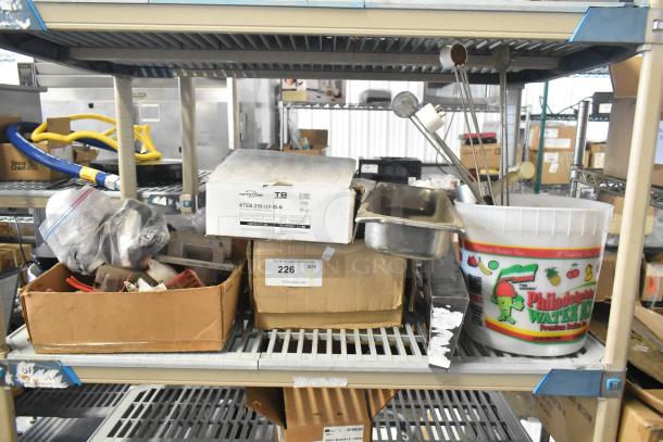 Tiered lot of various items including Flavor Burst parts, drop-in bin, Turbochef kickplate, ballasts. Multiple boxes and containers visible.