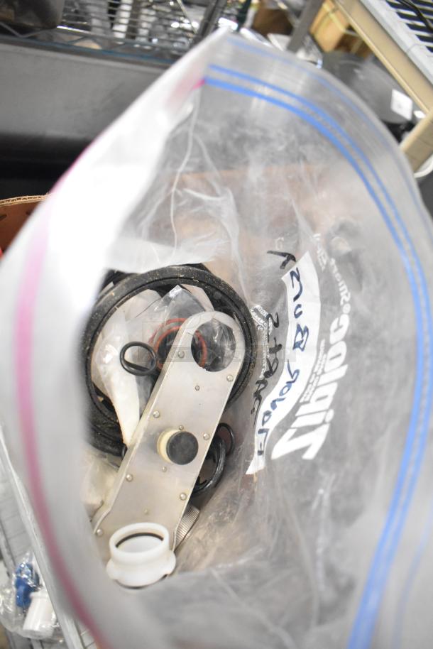 Auction lot with miscellaneous items in a Ziplock bag, including Flavor Burst parts and other components, labeled for identification.