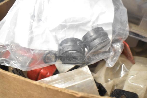 Box containing various items including Flavor Burst parts, Turbochef kickplate, and ballasts in assorted conditions.