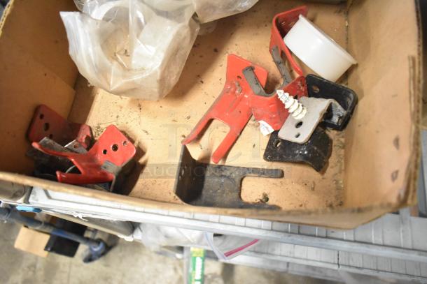 Box with assorted parts, including red metal brackets and plastic components. Includes Flavor Burst parts and Turbochef kickplate.