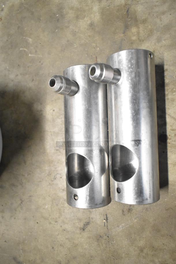 Various metal parts from tier lot including Flavor Burst components on concrete surface, showing minor wear.