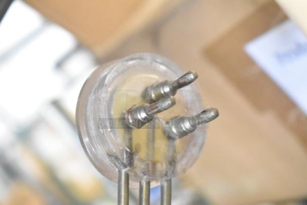 Alt text: "Close-up of metal connectors in a tier lot with Flavor Burst parts, drop-in bin, Turbochef kickplate, ballasts."